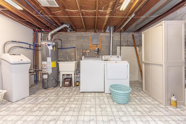 clothes washing area with sink, independent washer and dryer, and water heater