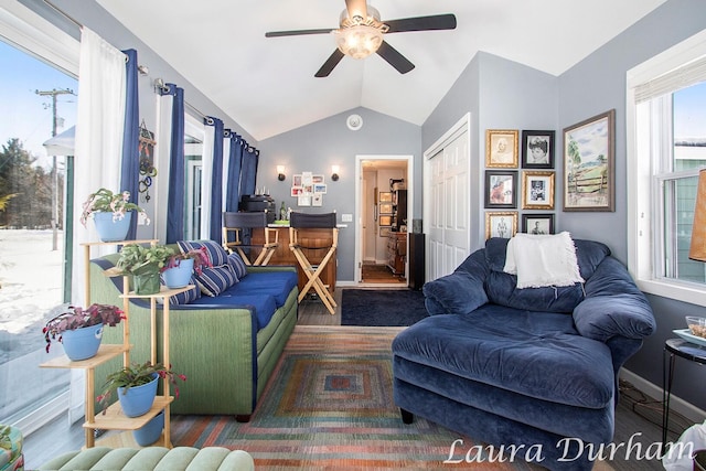 living room featuring vaulted ceiling, ceiling fan, and dark hardwood / wood-style flooring