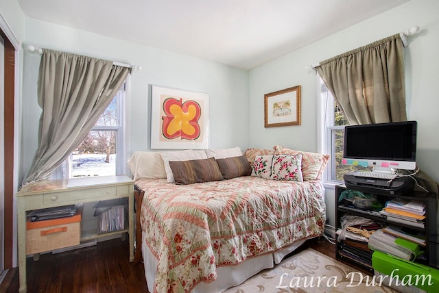 bedroom with wood-type flooring and multiple windows