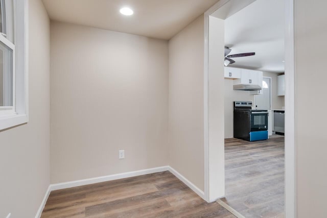 hall with hardwood / wood-style flooring