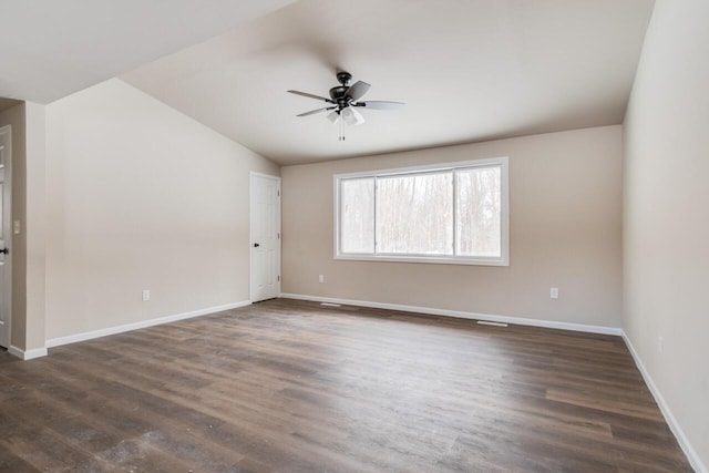 unfurnished room with ceiling fan, dark hardwood / wood-style flooring, and vaulted ceiling