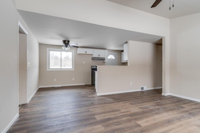 unfurnished living room featuring ceiling fan and hardwood / wood-style flooring