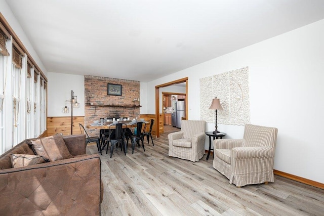 living room with light hardwood / wood-style floors and wooden walls