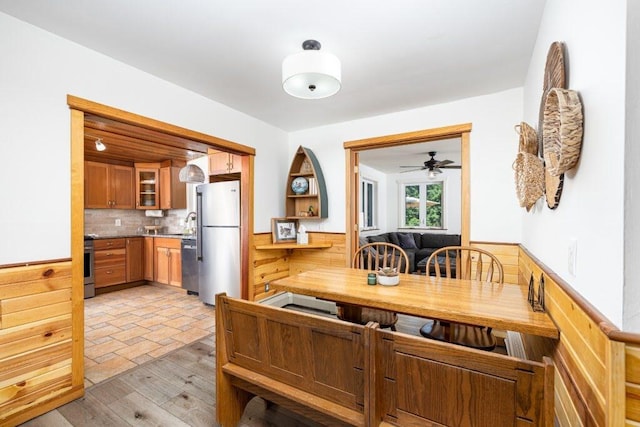 dining space with sink and light wood-type flooring