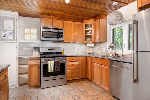 kitchen featuring pendant lighting, sink, light stone counters, wooden ceiling, and stainless steel appliances