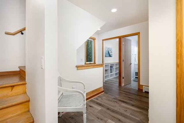 hallway with hardwood / wood-style flooring and baseboard heating