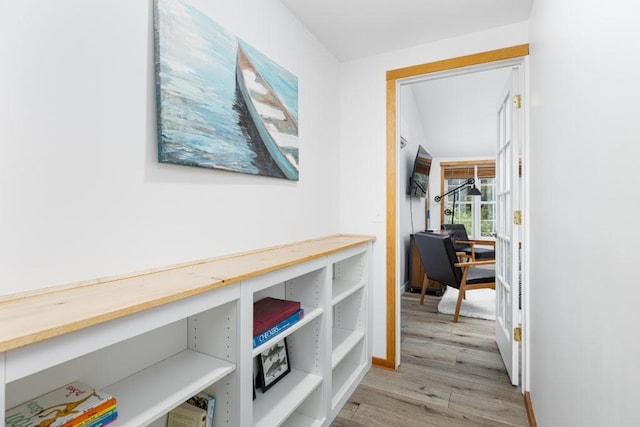 hallway with light hardwood / wood-style flooring