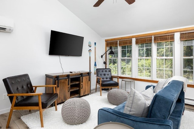 living room with hardwood / wood-style flooring, a wealth of natural light, lofted ceiling, and ceiling fan