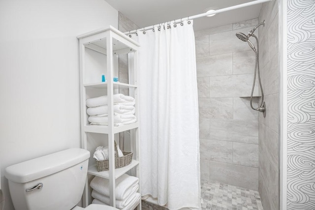 bathroom featuring toilet and a shower with curtain