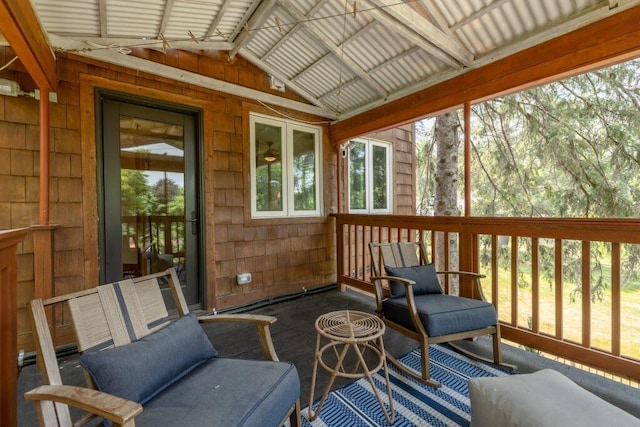 sunroom / solarium featuring plenty of natural light and vaulted ceiling