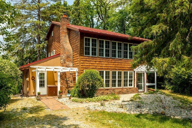 back of house featuring a pergola