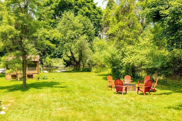 view of yard with a fire pit