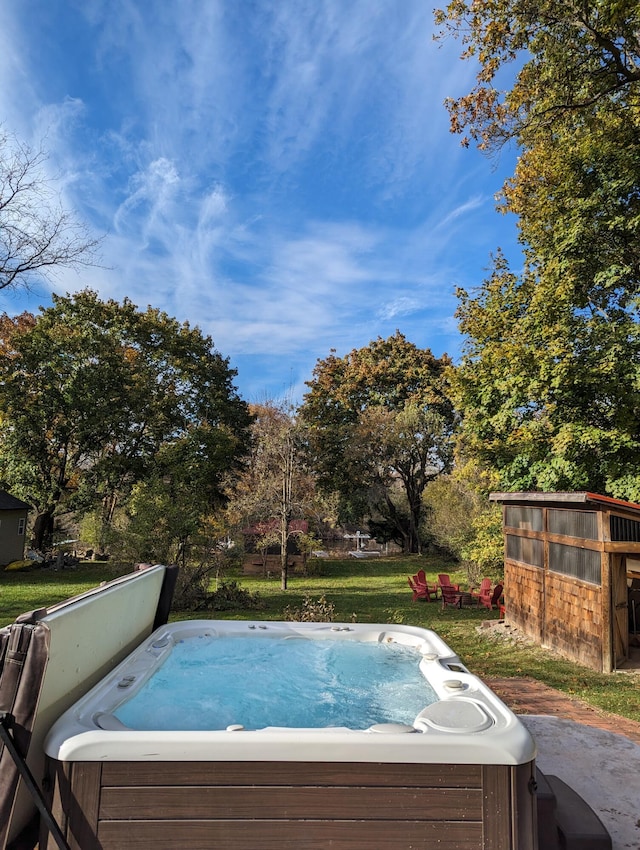 view of swimming pool with a hot tub