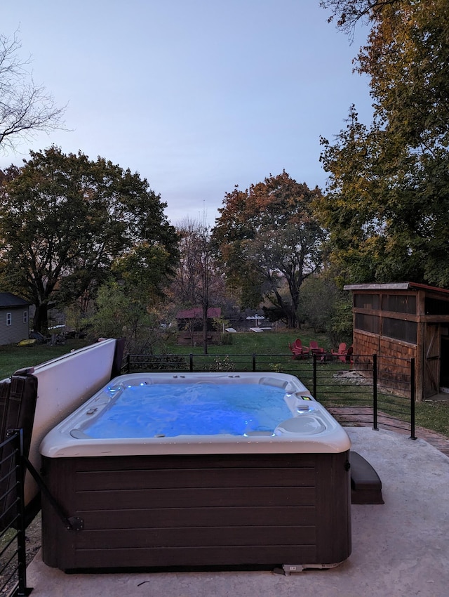 view of swimming pool with a hot tub