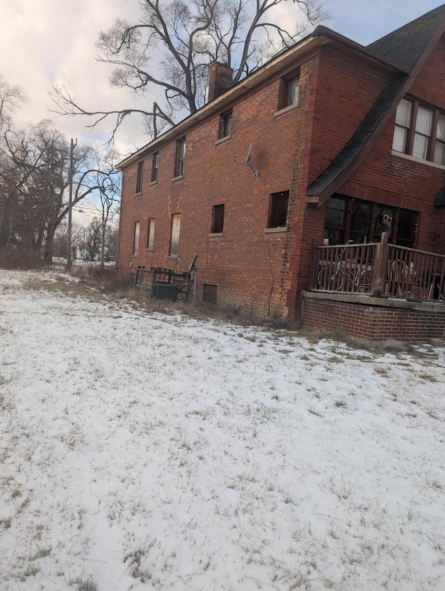 view of snow covered back of property