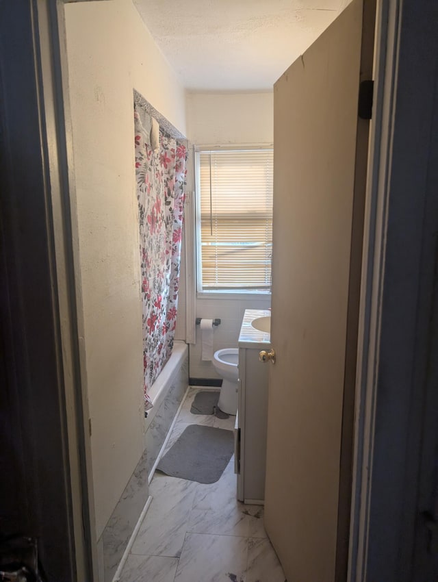 full bathroom featuring toilet, vanity, and shower / tub combo with curtain