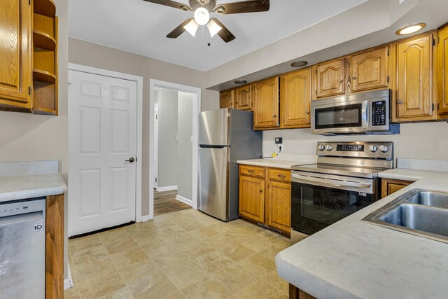 kitchen with ceiling fan, appliances with stainless steel finishes, and sink