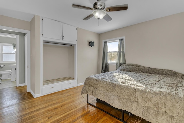 bedroom featuring ceiling fan, a closet, connected bathroom, and light hardwood / wood-style floors