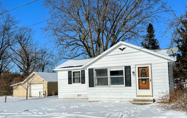 view of front of property with a garage and an outdoor structure