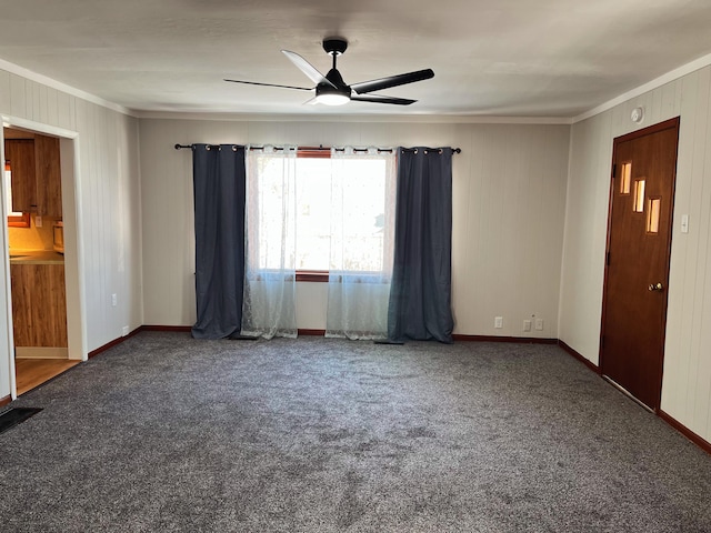 carpeted empty room with ceiling fan and ornamental molding