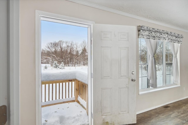 entryway featuring a textured ceiling, crown molding, and wood-type flooring