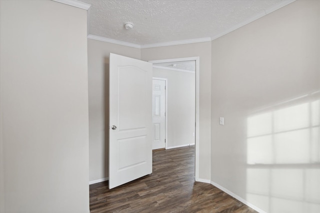 unfurnished room with dark hardwood / wood-style floors, a textured ceiling, and ornamental molding