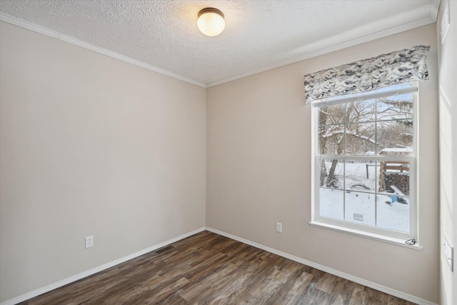 spare room with a healthy amount of sunlight, dark hardwood / wood-style flooring, and a textured ceiling