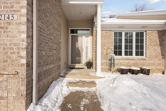 view of snow covered property entrance