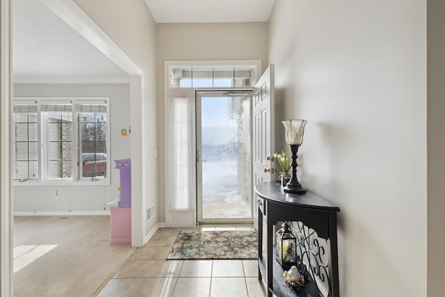 carpeted entryway with crown molding