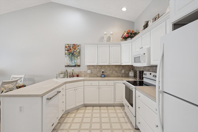 kitchen featuring sink, white appliances, white cabinets, and vaulted ceiling