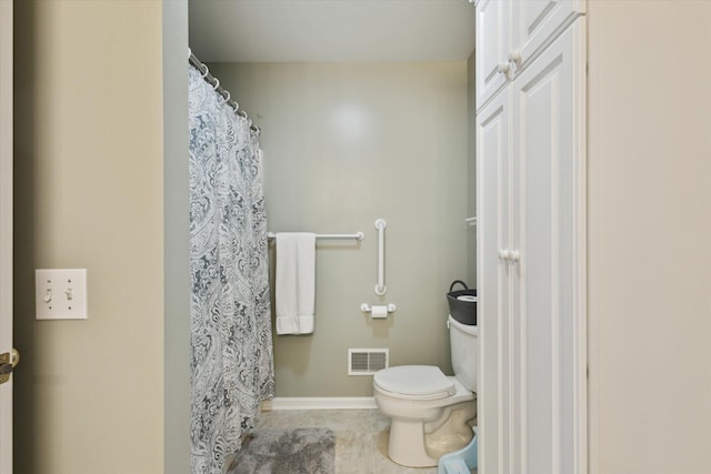 bathroom featuring toilet and tile patterned floors