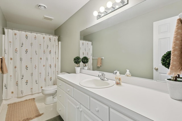 bathroom featuring toilet and vanity