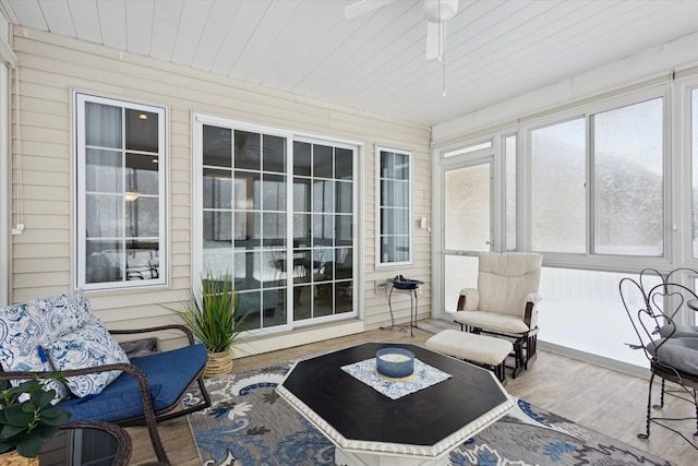 sunroom / solarium featuring ceiling fan