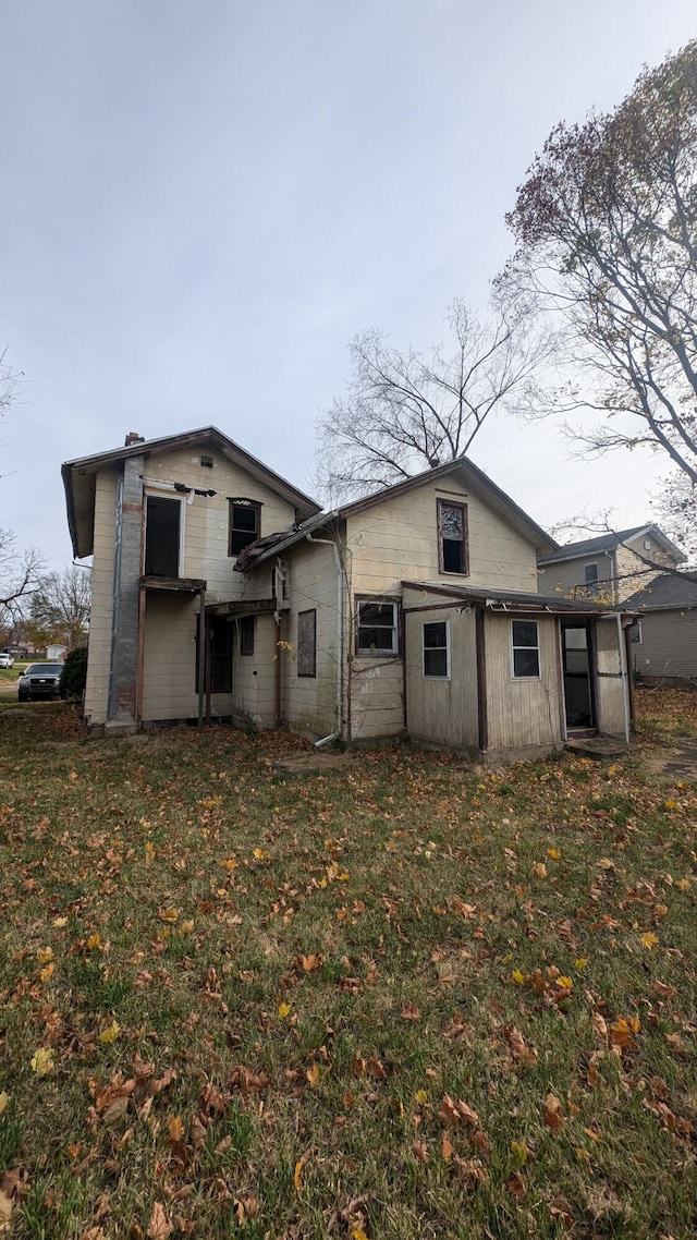 rear view of house with a lawn