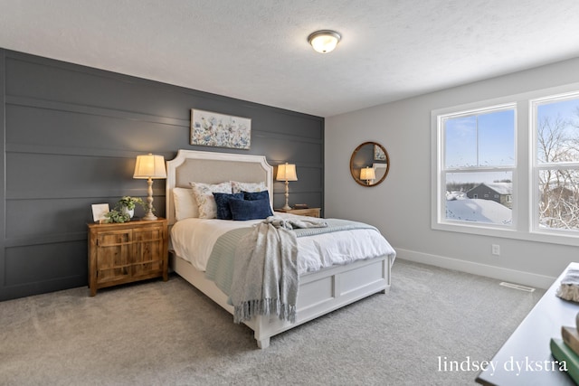 carpeted bedroom with a textured ceiling