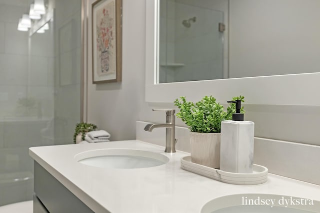 bathroom featuring an enclosed shower and vanity