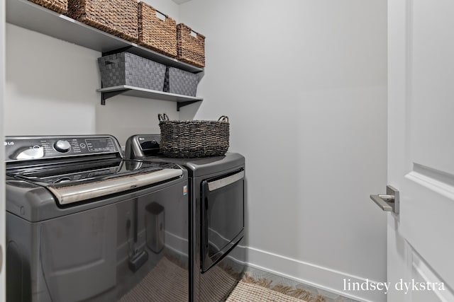 laundry area featuring washing machine and clothes dryer