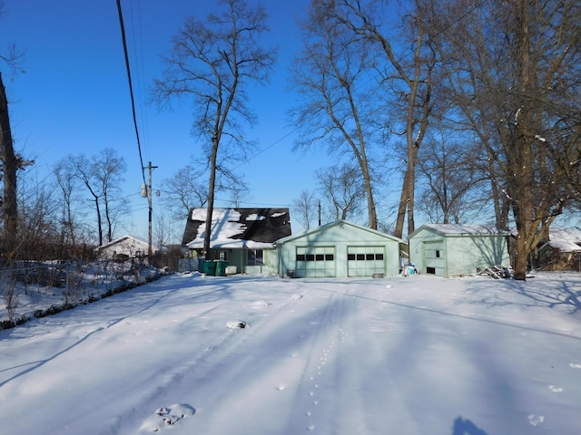 exterior space with a garage and an outbuilding