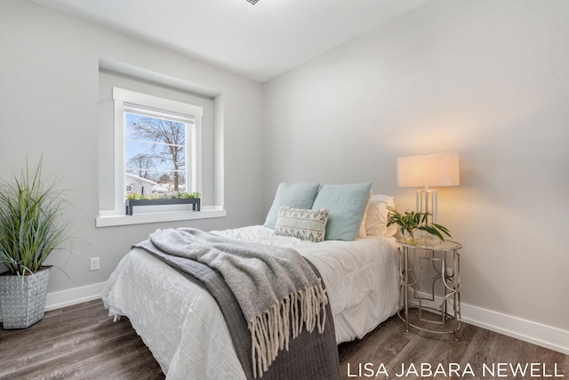 bedroom featuring vaulted ceiling and dark hardwood / wood-style flooring