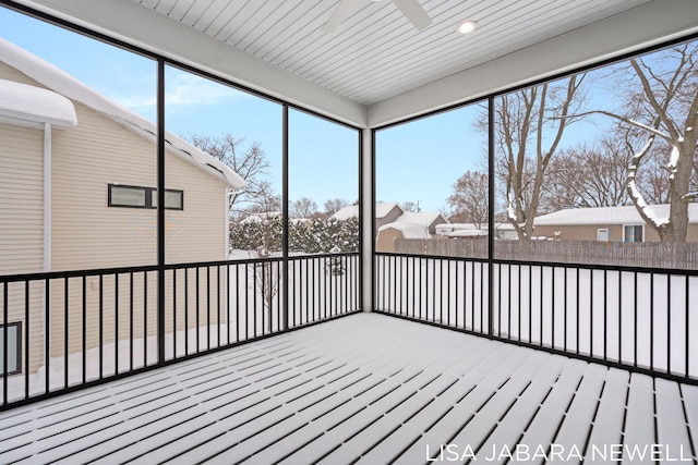 unfurnished sunroom featuring ceiling fan