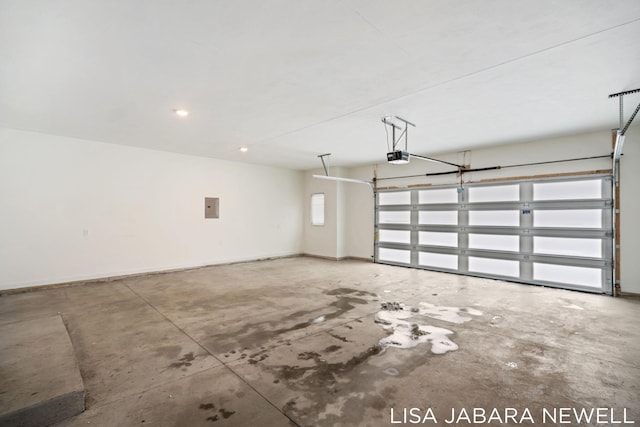 garage with a garage door opener and electric panel