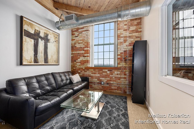 carpeted living room featuring brick wall, beamed ceiling, and wood ceiling