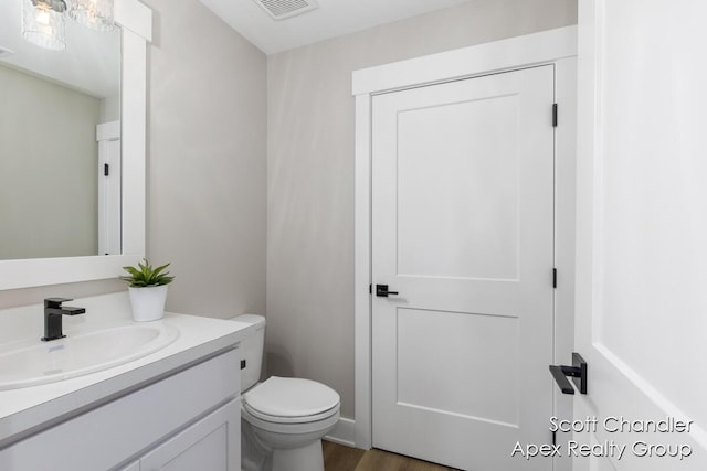 bathroom with toilet and vanity