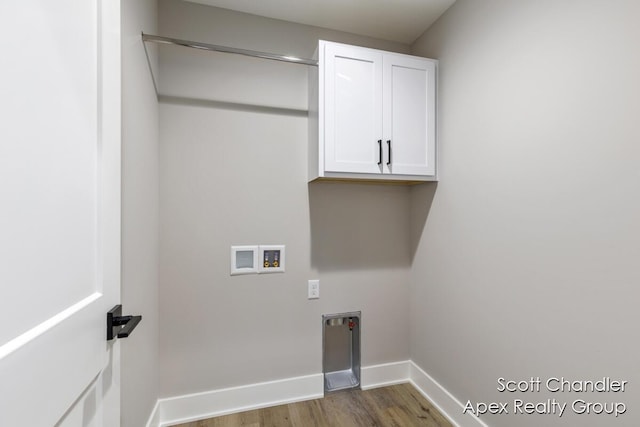 laundry room with wood-type flooring, washer hookup, and cabinets