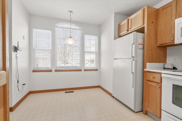 kitchen with decorative light fixtures and white appliances