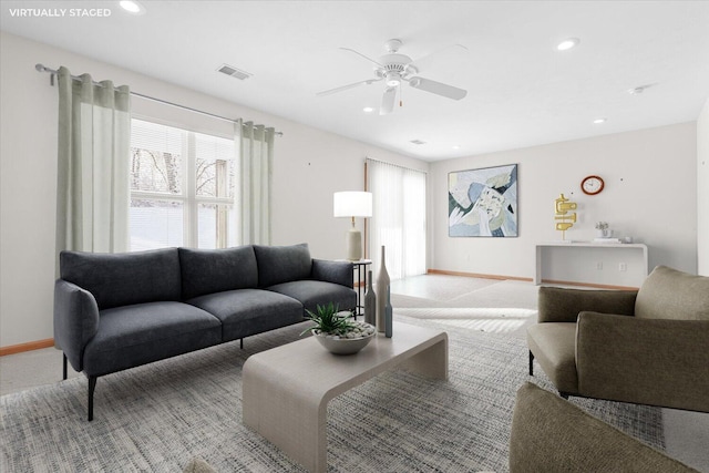 living room with ceiling fan and light carpet