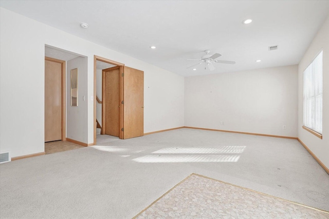 carpeted empty room featuring ceiling fan