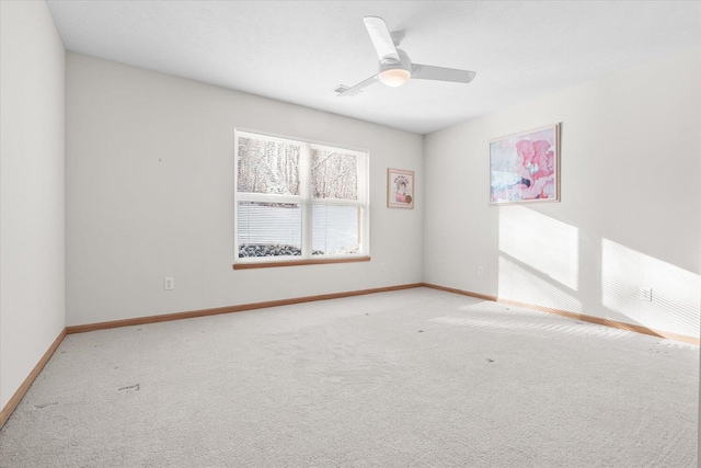 empty room featuring light carpet and ceiling fan