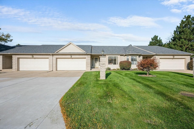 ranch-style home featuring a garage and a front lawn