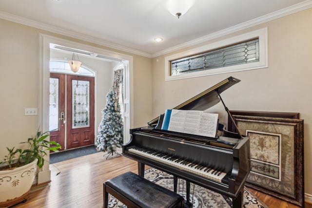 misc room featuring hardwood / wood-style floors, plenty of natural light, and ornamental molding